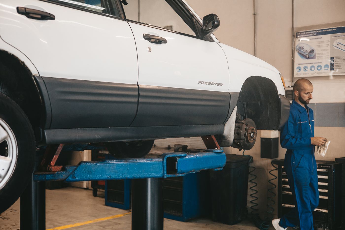 A car on a lift in a clean repair shop